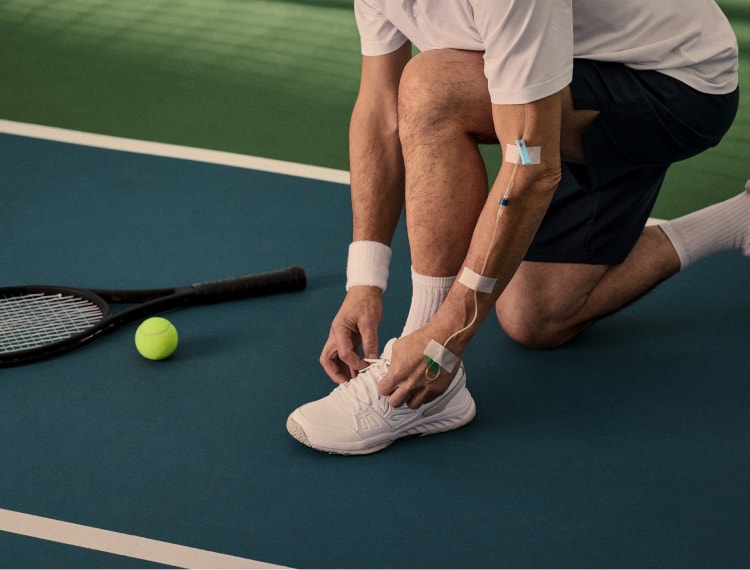 Tennis player tying his shoe