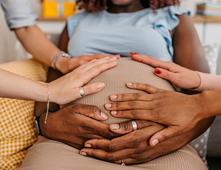 multiple hands on belly