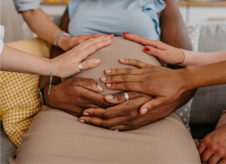 multiple hands on belly